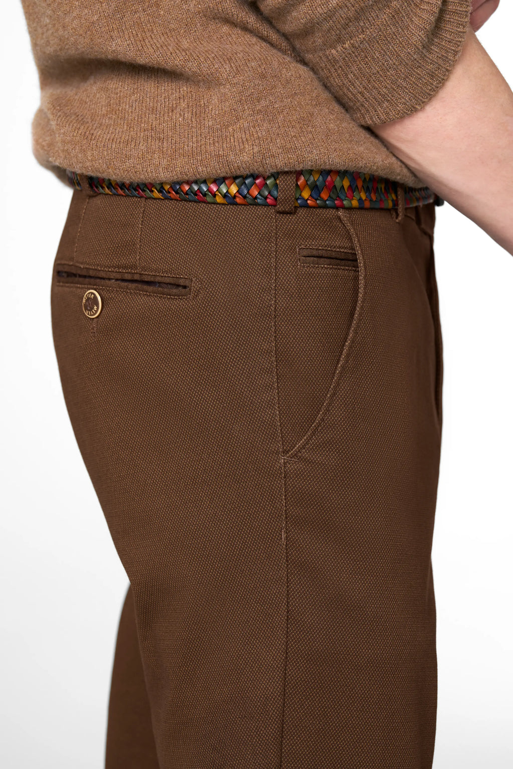 Brown pants with a colorful belt on a white background